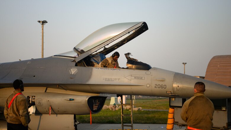 Maintainers perform maintenance on a jet.