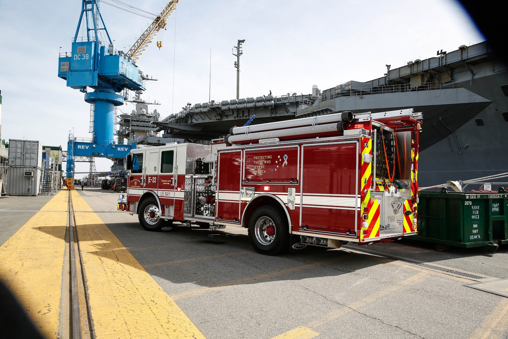 Norfolk Naval Shipyard's Fire Engine 22 with the USS Harry S. Truman (CVN 75) in the background.