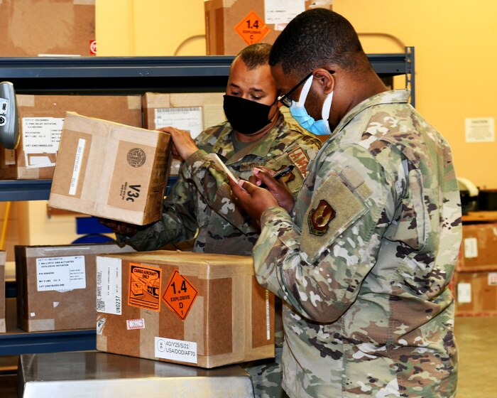 Men inspecting boxes