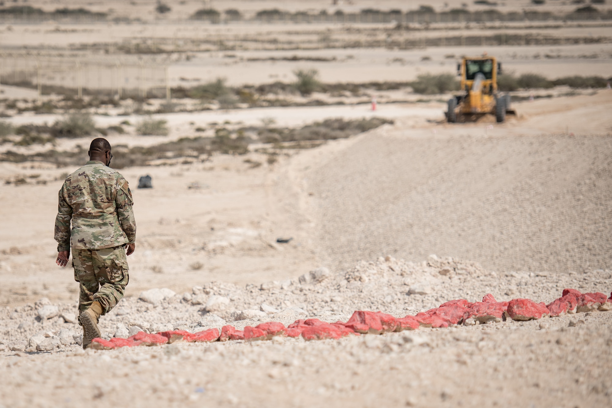 an airman walks near a construction project