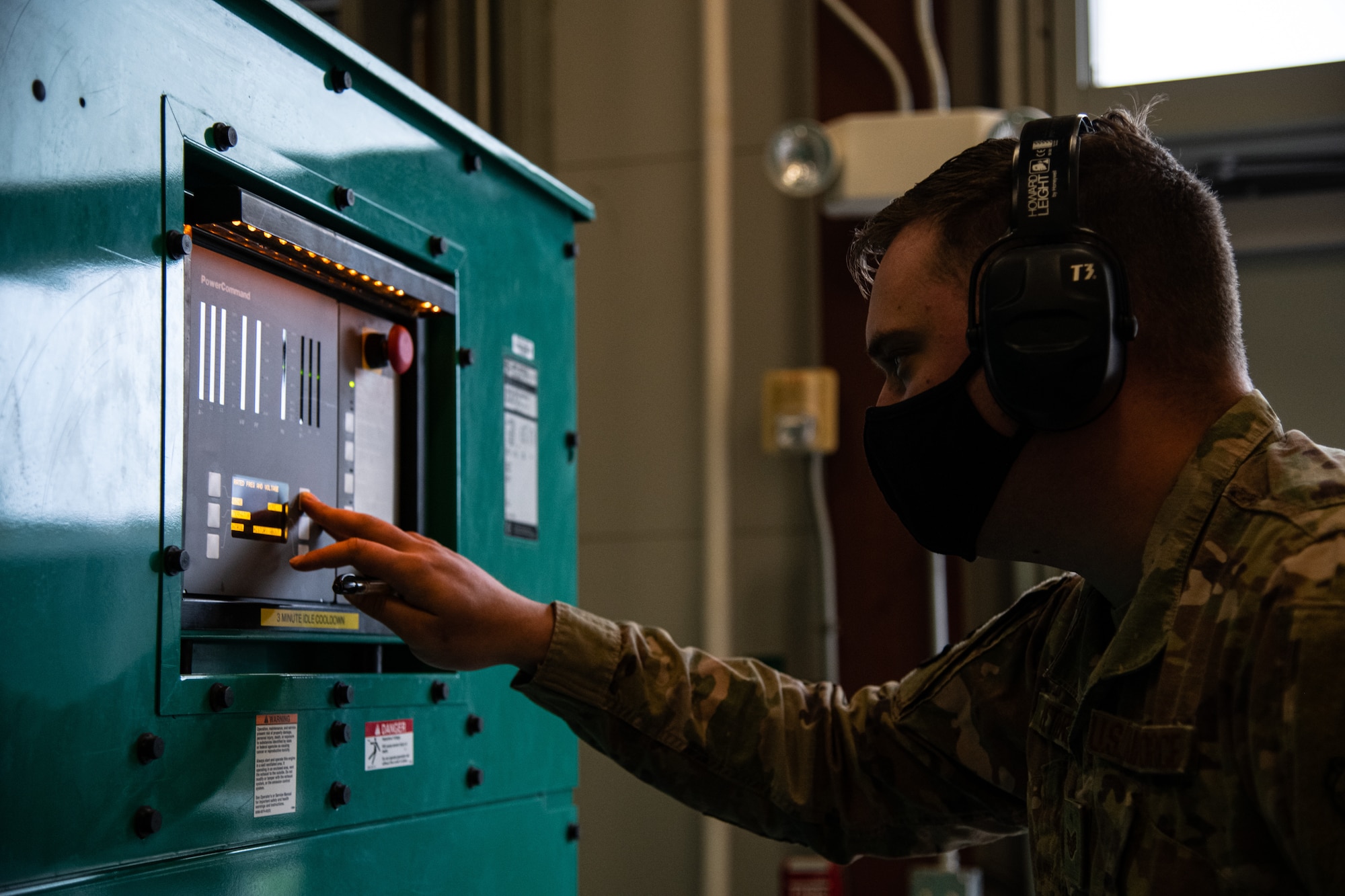 Staff Sgt. David Peterson, 436th Civil Engineer Squadron electrical power production craftsman, checks generator data  during a monthly inspection test at Dover Air Force Base, Delaware, April 12, 2021. The electrical power production team conducts monthly tests on base emergency generators to ensure they are functioning in case of an electrical power outage. (U.S. Air Force photo by Senior Airman Marco A. Gomez)