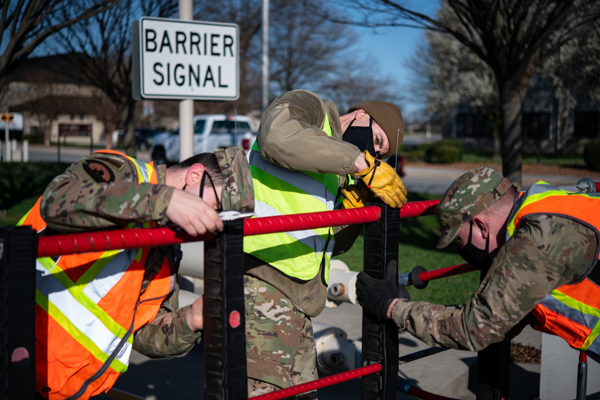 From the left, Senior Airman James Wolfley, 436th Civil Engineer Squadron electrical power production journeyman, Staff Sgt. Joseph Tominello, 436th CES electrical power production craftsman, and Master Sgt. Trevor Wilkinson, 436th CES noncommissioned officer in charge of electrical power production, replace encasings for a ground automobile retractable barrier (GRAB) net, at Dover Air Force Base, Delaware, April 3, 2021. The power production flight’s duties include servicing the GRAB net monthly. (U.S. Air Force photo by Senior Airman Marco A. Gomez)