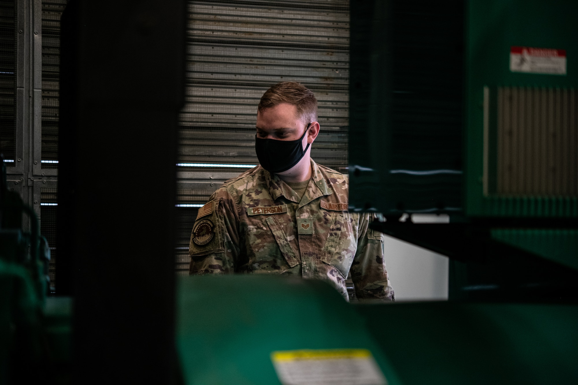 Staff Sgt. David Peterson, 436th Civil Engineer Squadron electrical power production craftsman, inspects a generator at Dover Air Force Base, Delaware, April 12, 2021. Post-test checks are conducted during preventative maintenance after the generator runs for an hour. (U.S. Air Force photo by Senior Airman Marco A. Gomez)