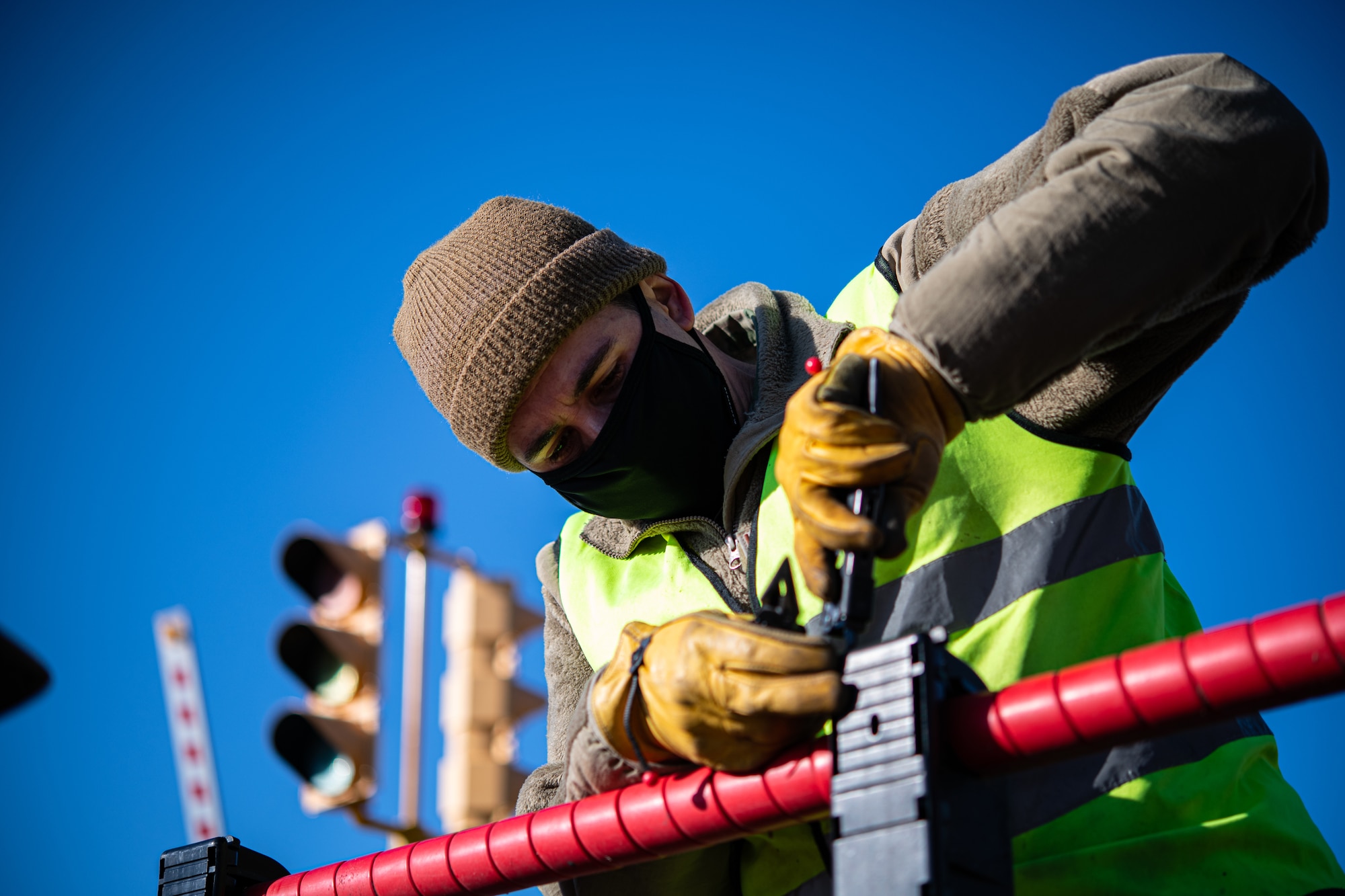 Staff Sgt. Joseph Tominello, 436th Civil Engineer Squadron electrical power production craftsman, pulls out metal wiring from a ground automobile retractable barrier (GRAB) net encasing, at Dover Air Force Base, Delaware, April 3, 2021. The encasings must be serviced periodically due to weather conditions and the constant pressure they receive when driven over by vehicles. (U.S. Air Force photo by Senior Airman Marco A. Gomez)