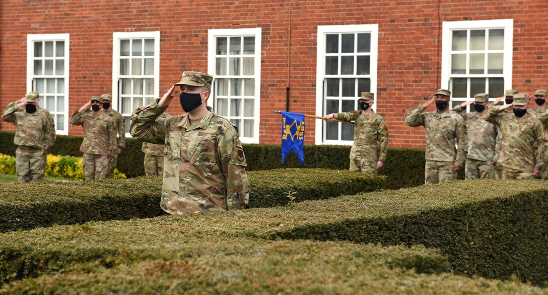 U.S. Air Force Master Sgt. Garrett Hetzel, 95th Reconnaissance Squadron first sergeant, leads Retreat as part of the first sergeant symposium at Royal Air Force Mildenhall, England, April 20, 2021. The base’s First Sergeant Council hosted a first sergeant symposium April 19 to 23 for potential and interim first sergeants. Topics included maintenance of discipline, administrative demotions and counseling. (U.S. Air Force photo by Karen Abeyasekere)