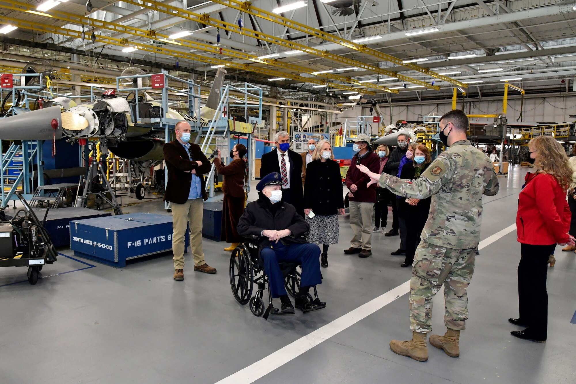 Air Force Col. (Ret.) Gail Halvorsen (center), is briefed by Lt. Col. Aaron Rivers, 309th Aircraft Maintenance Wing commander, about aircraft maintenance operations during a tour of a 309th AMXG facility April 16, 2021, at Hill Air Force Base, Utah. During their visit, Halvorsen and family members also toured the Hill Aerospace Museum and witnessed an F-35A Lightning II Demonstration Team practice. (U.S. Air Force photo by Todd Cromar)