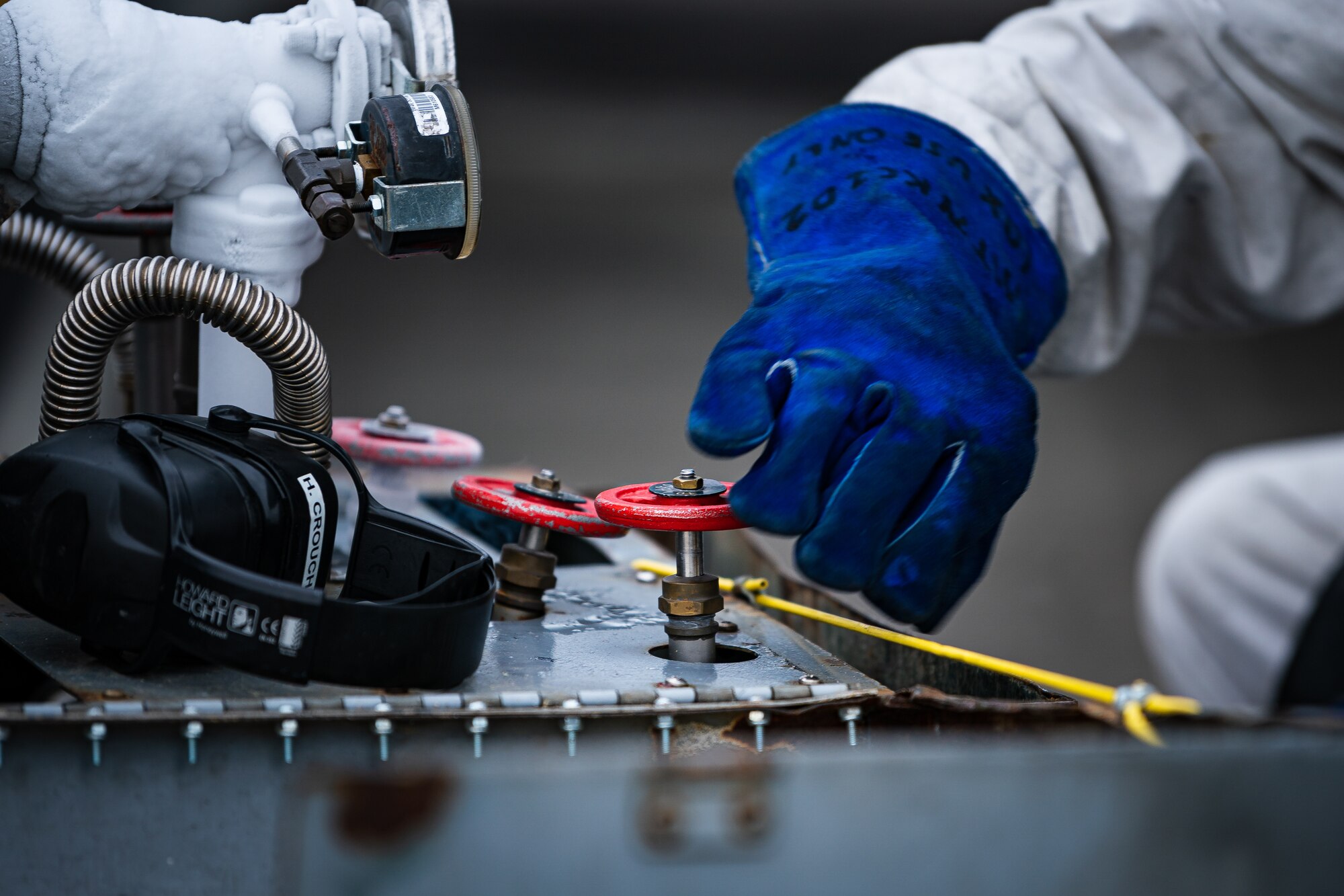 A photo of an Airman turning a valve on a liquid oxygen cart