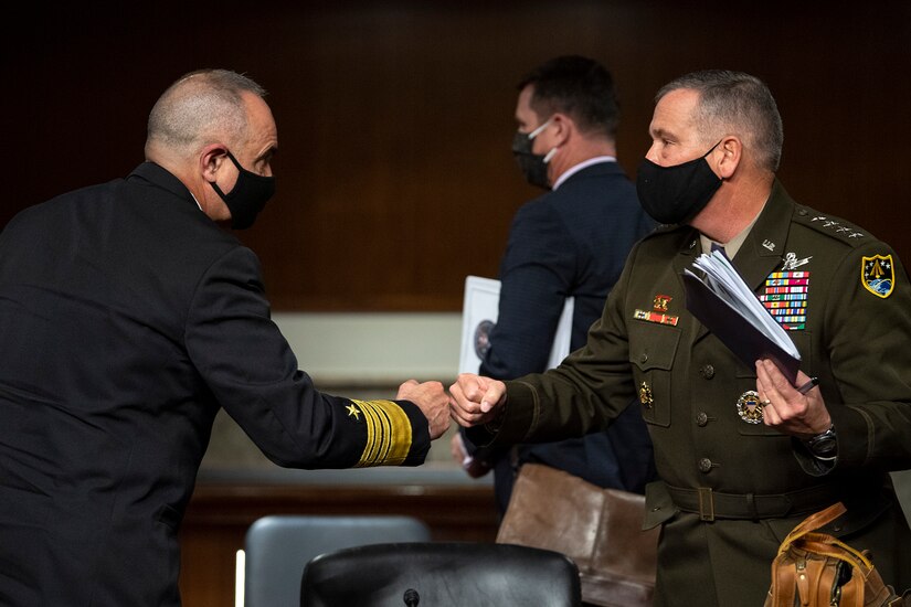 Military officers fist bump following SASC hearing.