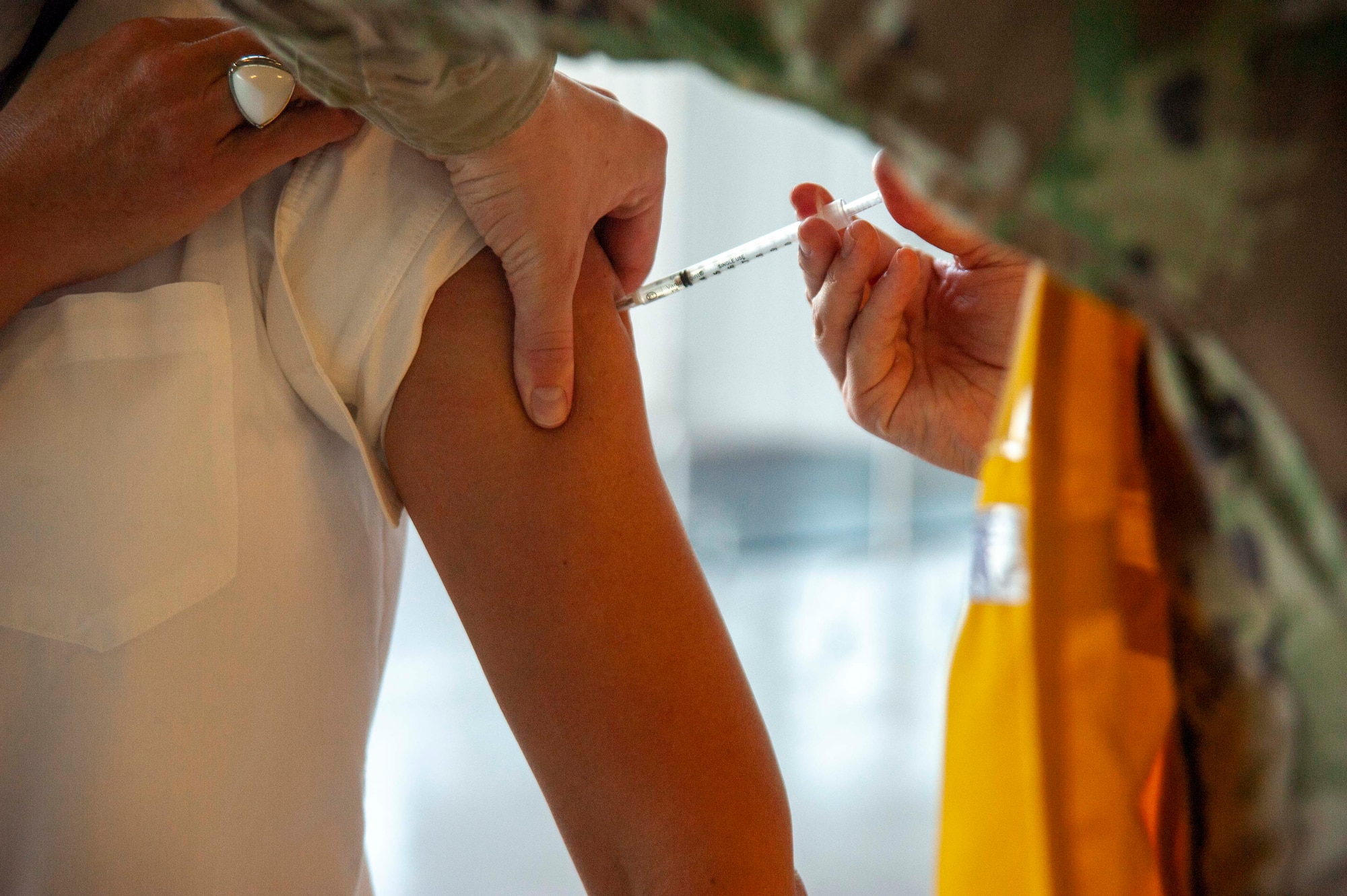 Iryiva Bazaria, a member of Team MacDill, receives a vaccination at a COVID-19 vaccination distribution site, located on MacDill Air Force Base, Fla., March 12, 2021. Each COVID-19 vaccine is prepared on-site and must be used within 6 hours of preparation and removal from storage. (U.S. Air Force photo by Airman 1st Class David D. McLoney)