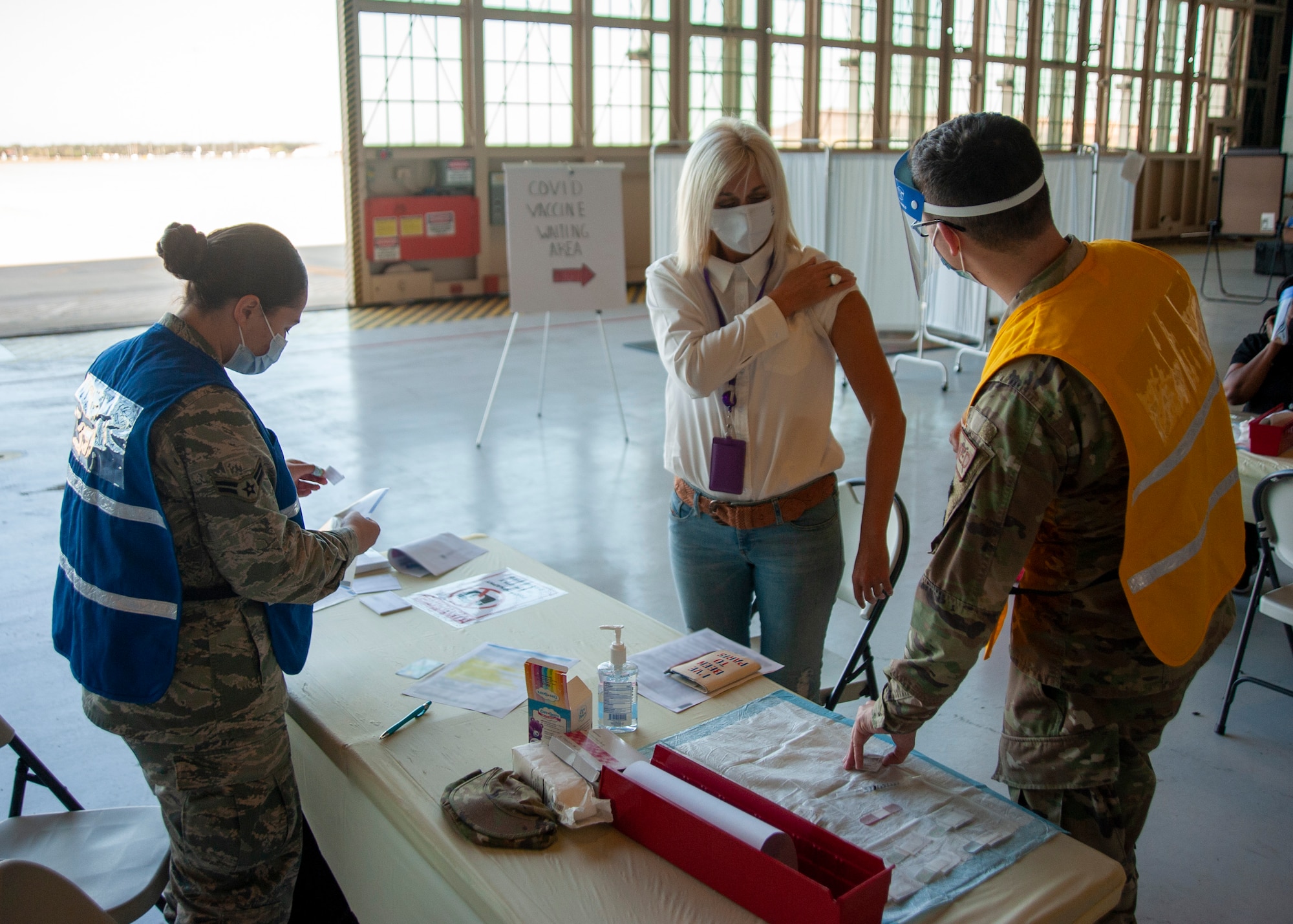 Iryiva Bazaria, a member of Team MacDill, prepares to receive a vaccination at a COVID-19 vaccination distribution site, located on MacDill Air Force Base, Fla., March 12, 2021. The vaccine was first offered to medical personnel, firefighters, security forces personnel and all first responders stationed at MacDill. (U.S. Air Force photo by Airman 1st Class David D. McLoney)