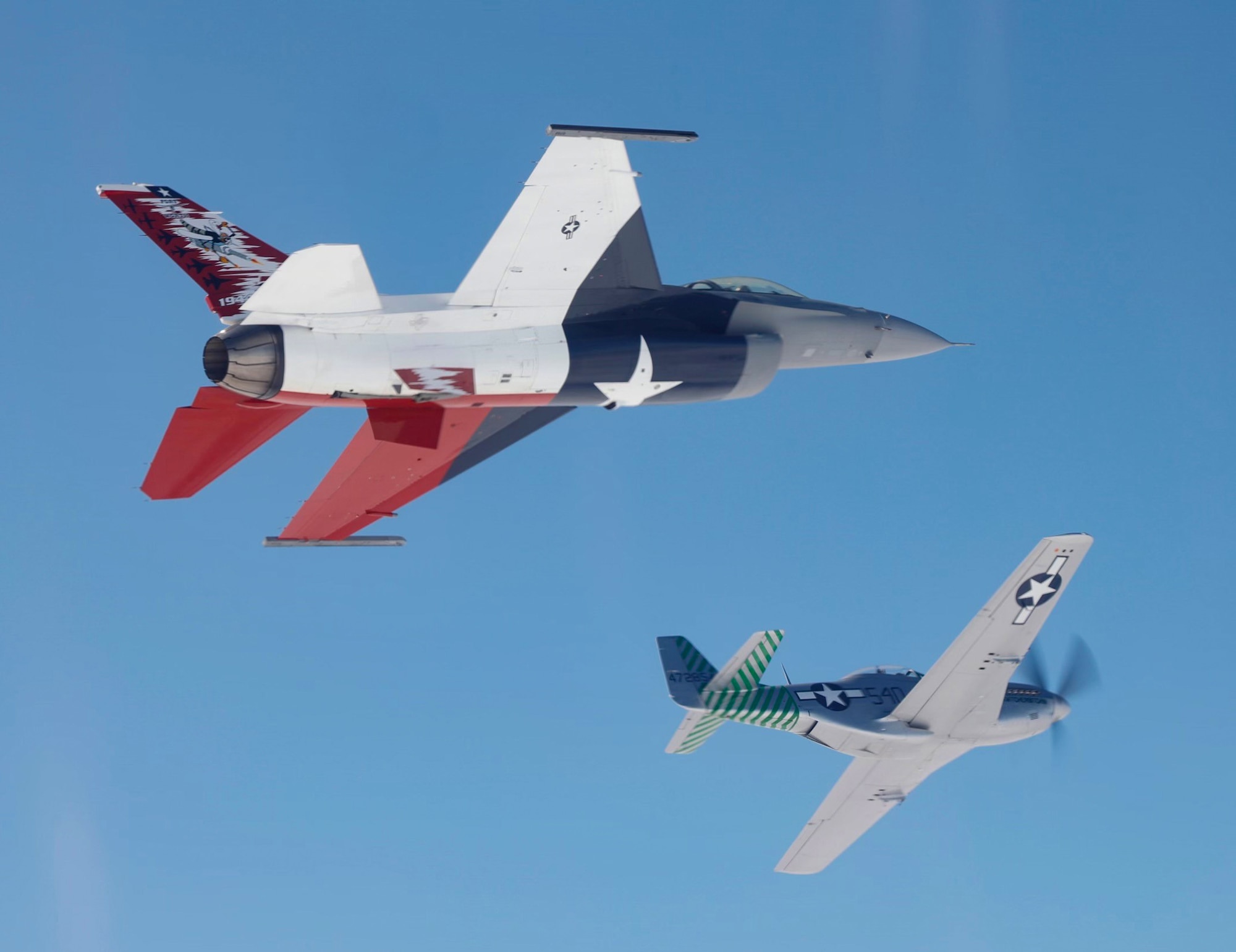 A P-51 Mustang and a 457th Fighter Squadron F-16 Fighting Falcon fly over the U.S. eastern coast on Friday, April 16, 2021. The flight commemorated the 75th anniversary of the squadron, which was activated on Oct. 21, 1944. The P-51 was the first aircraft assigned to the squadron. (U.S. Air Force photo by 1st Lt. Savanah Bray)
