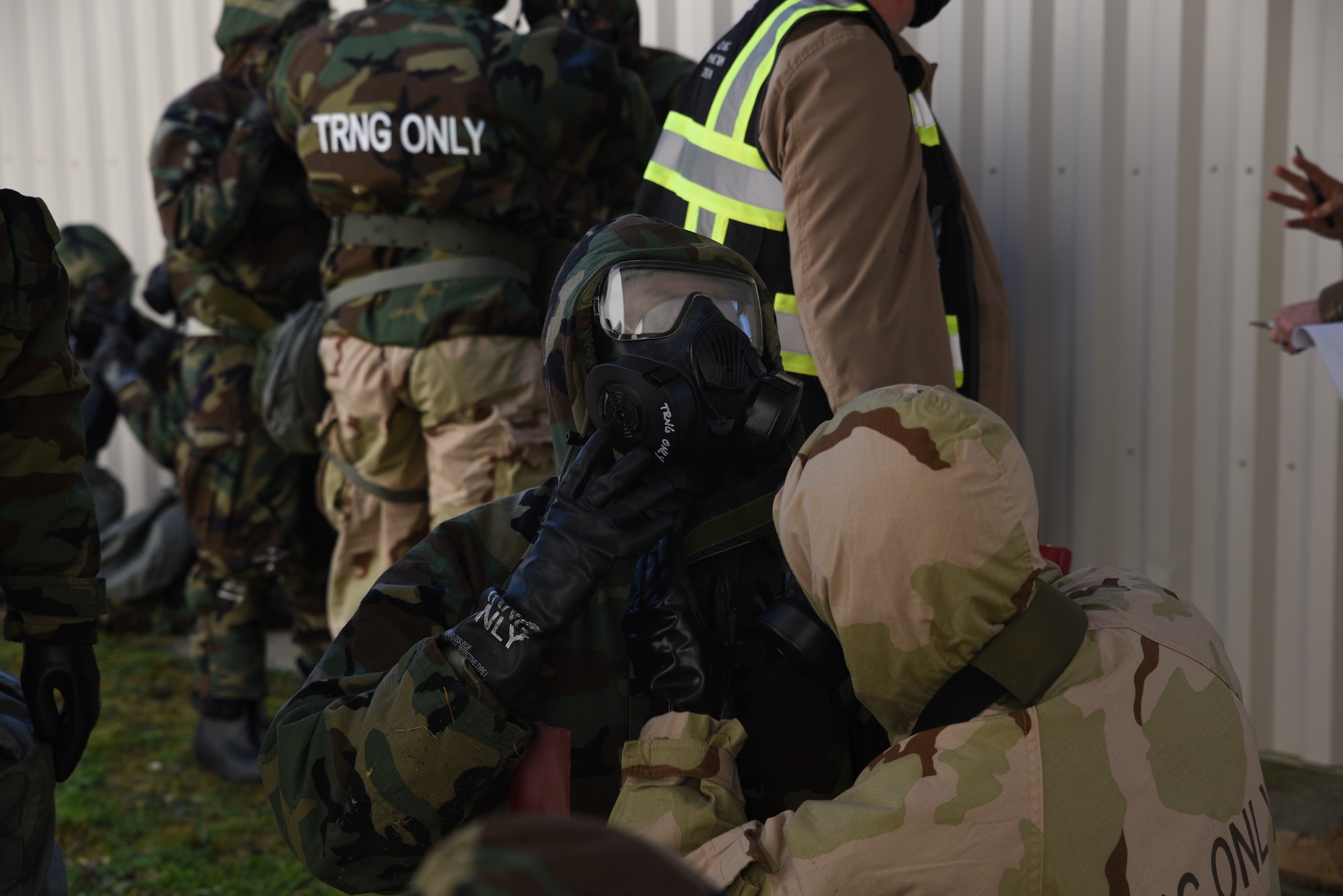 Airmen from the 62nd Airlift Wing and 627th Air Base Group don chemical, biological, radiological and nuclear defense gear during Exercise Rainier War on Joint Base Lewis-McChord, Washington, on April 21, 2021. Exercise Rainier War tests the 62nd AW’s capability to plan, generate and execute a deployment tasking, sustain contingency operations, demonstrate Full Spectrum Readiness while executing Agile Combat Employment in a Contested, Degraded and Operationally Limited environment. (U.S. Air Force photo by Senior Airman Zoe Thacker)