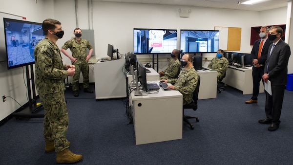 DAHLGREN, Va. (April 13, 2021) Instructor Fire Controlman (Aegis) 1st Class Kirt Palmer executes an Aegis Virtual Maintenance Trainer 
demonstration for Chief of Staff to the Acting Secretary of the Navy, Mr. Tommy Ross, and Director, Navy Staff Office of the Chief of Naval Operations, Mr. Andy Haeuptle, Senior Executive Service, during their tour at the AEGIS Training and Readiness Center April 13. (U.S. Navy photo by Michael Bova)