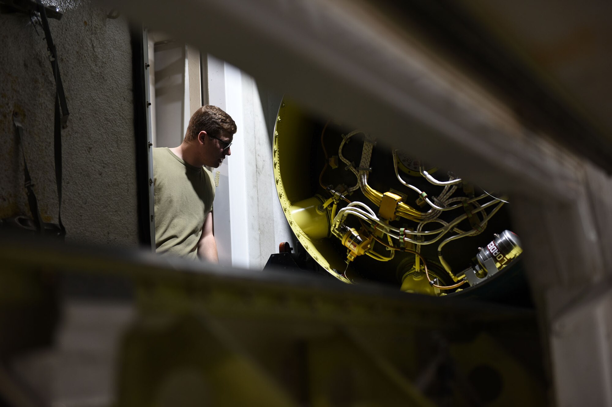 Airman peers inside of the T.E. van to inspect the booster of the missile.