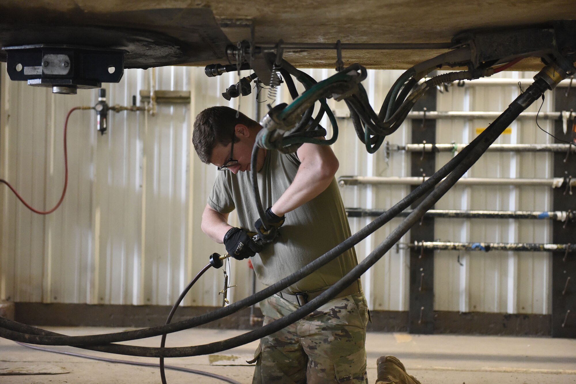 Airmen connects two cords as preparation for a missile roll transfer.