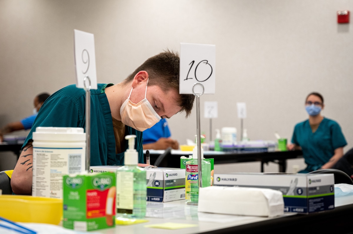 A corpsman prepares vaccines.