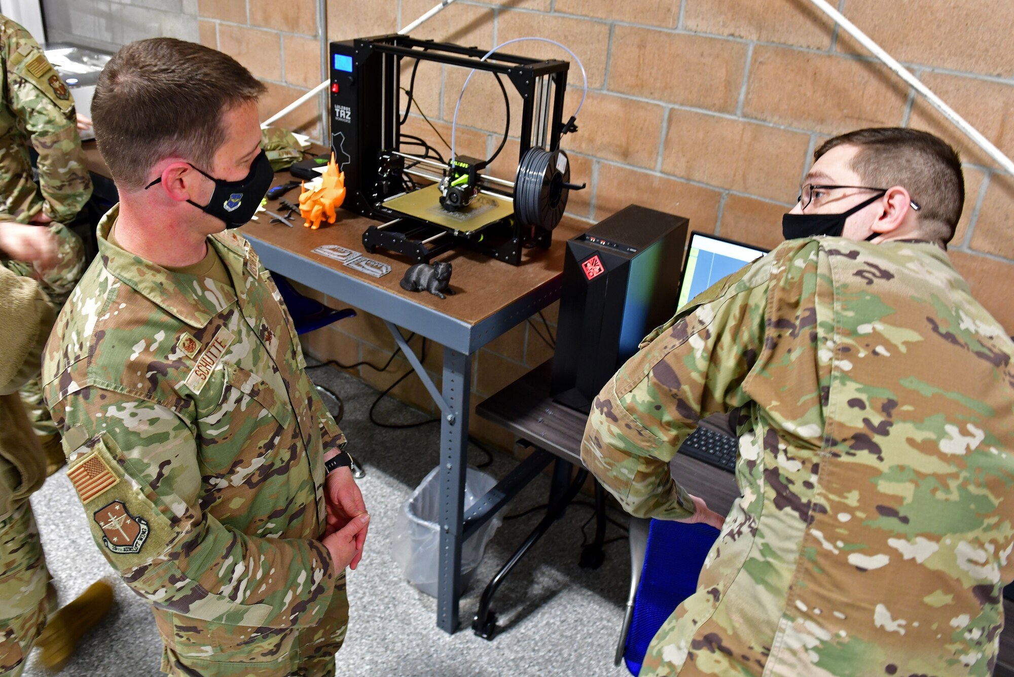 An Airman demonstrates a 3D printer