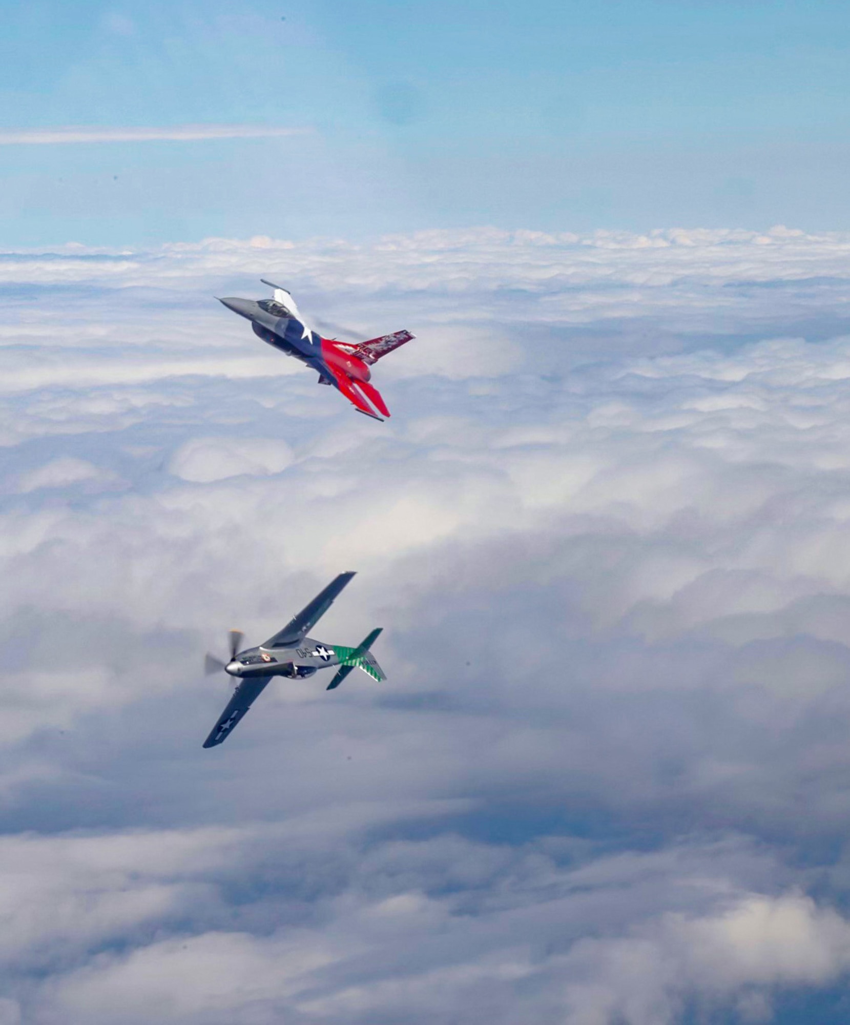 A P-51 Mustang and a 457th Fighter Squadron F-16 Fighting Falcon fly over the U.S. east coast Friday, April 16, 2021. The flight commemorated the 75th anniversary of the squadron, which was activated on Oct. 21, 1944. The P-51 was the first aircraft assigned to the squadron. (U.S. Air Force photo by 1st Lt. Savanah Bray)
