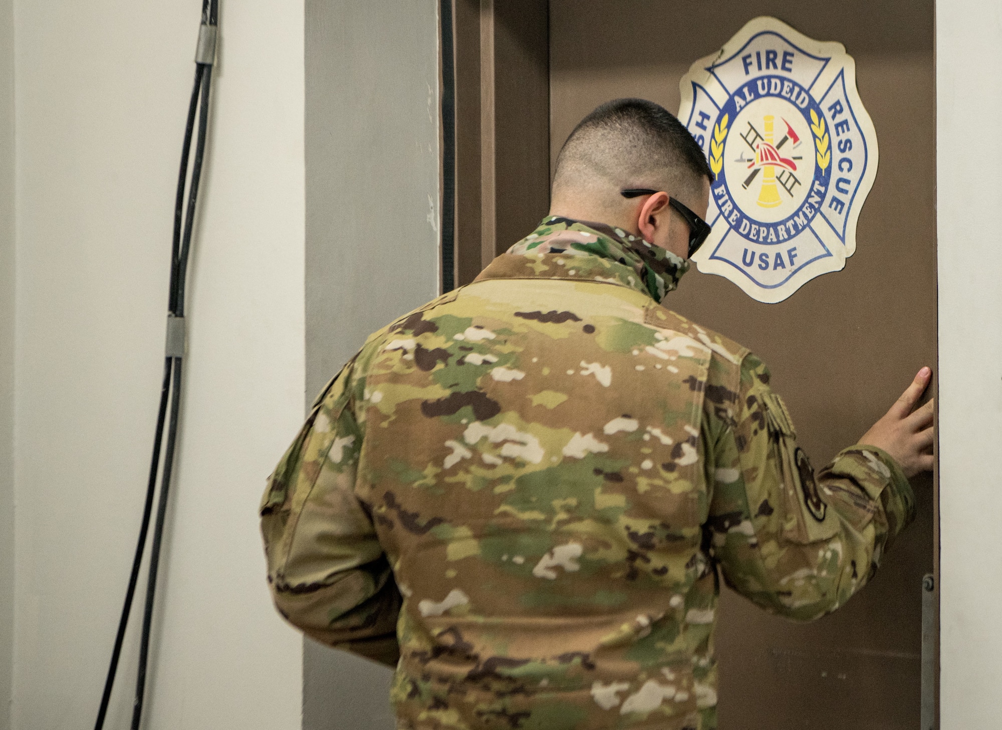 an airman exits a door