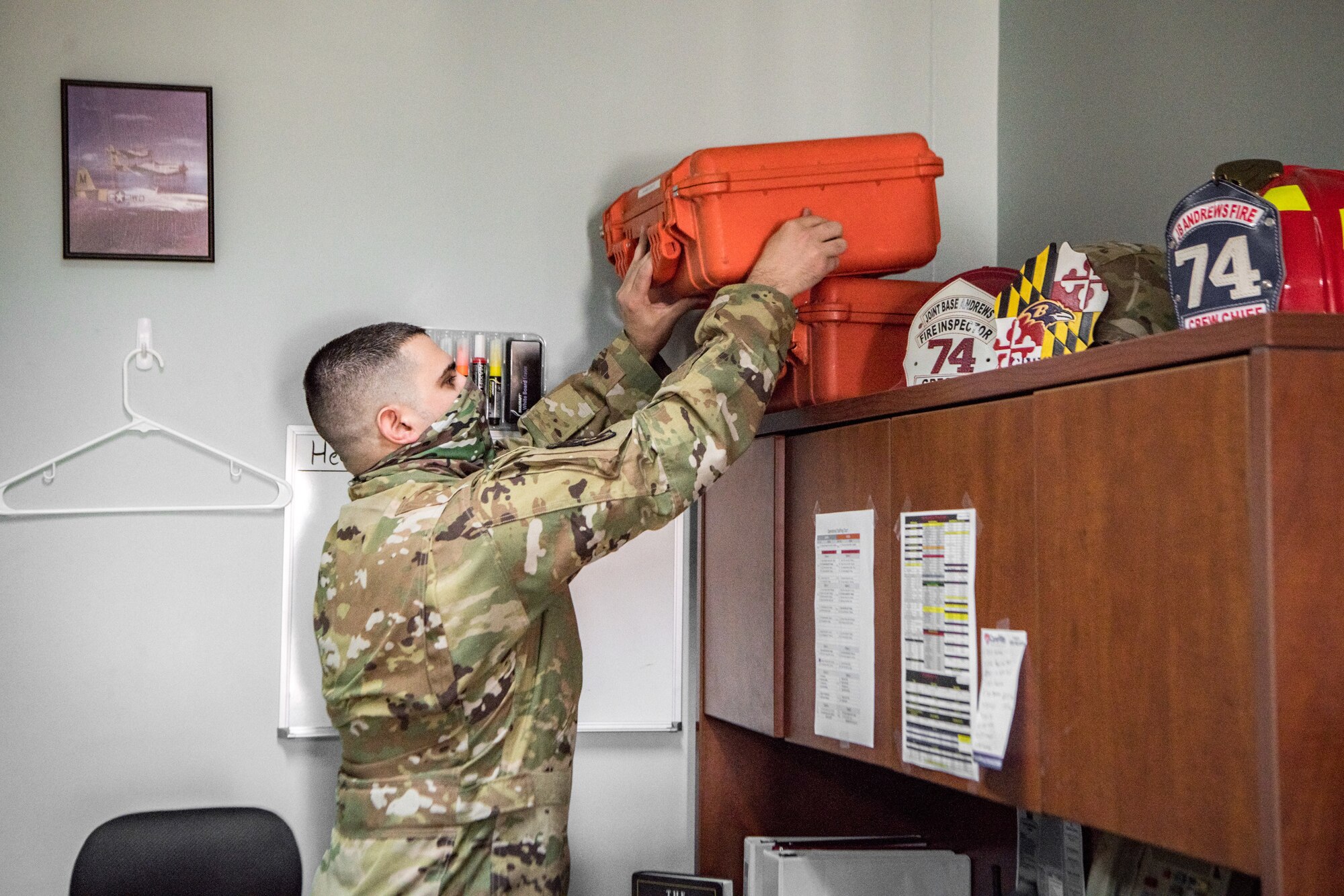 A man places a box on a shelf