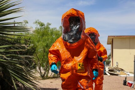 Sgts. Chaz Rapp and Rjhun Rimon with the 92nd Civil Support Team, Nevada National Guard, search for hazardous materials in level-A fully encapsulated chemical entry suits during training scenarios for Exercise Desert Torch, April 20, 2021, in Las Vegas.