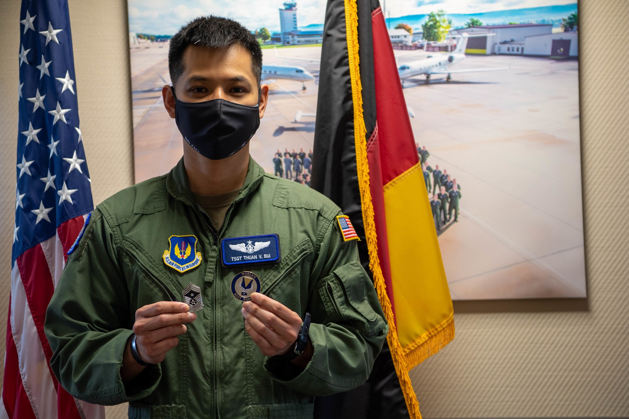 An Airman holding two coins.