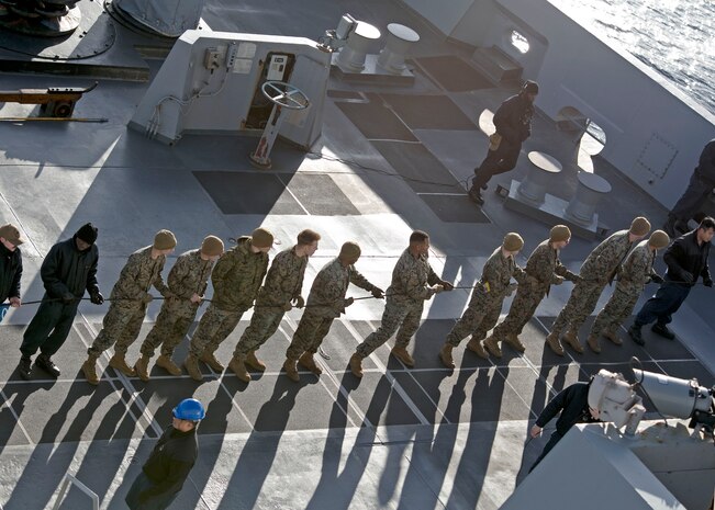 Sailors assigned to the amphibious transport dock ship USS San Antonio (LPD 17) and Marines assigned to the 24th Marine Expeditionary Unit (24th MEU) handle the phone and distance line during a replenishment-at-sea with the Lewis and Clark-class dry cargo ship USNS Supply Ship Robert E. Peary (T-AKE 5), not pictured, April 12, 2021.