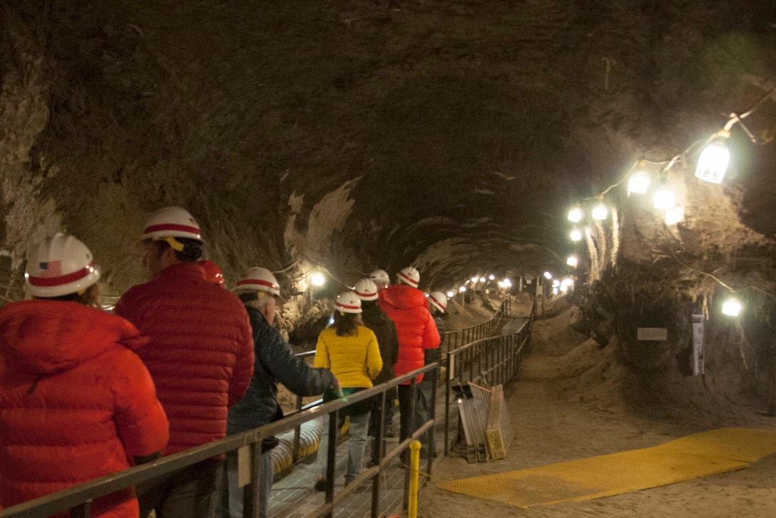 A group of people explore a tunnel.