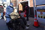 Petty Officer 2nd Class Kristin Matuska, a reservist machinery technician at Coast Guard Station New York, assists residents at a FEMA COVID-19 vaccination site in Brooklyn, New York, March 2, 2021. Coast Guard reservists have been deployed to assist with Community Vaccination Center operations organized by FEMA, U.S. Department of Health and Human Services, and state, local, tribal and territorial partners, to support national goals for COVID-19 health and safety and vaccine distribution. (Coast Guard photo by Petty Officer 2nd Class Cory J. Mendenhall)