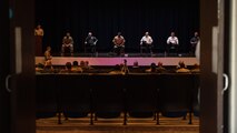Group of people sitting on a stage.