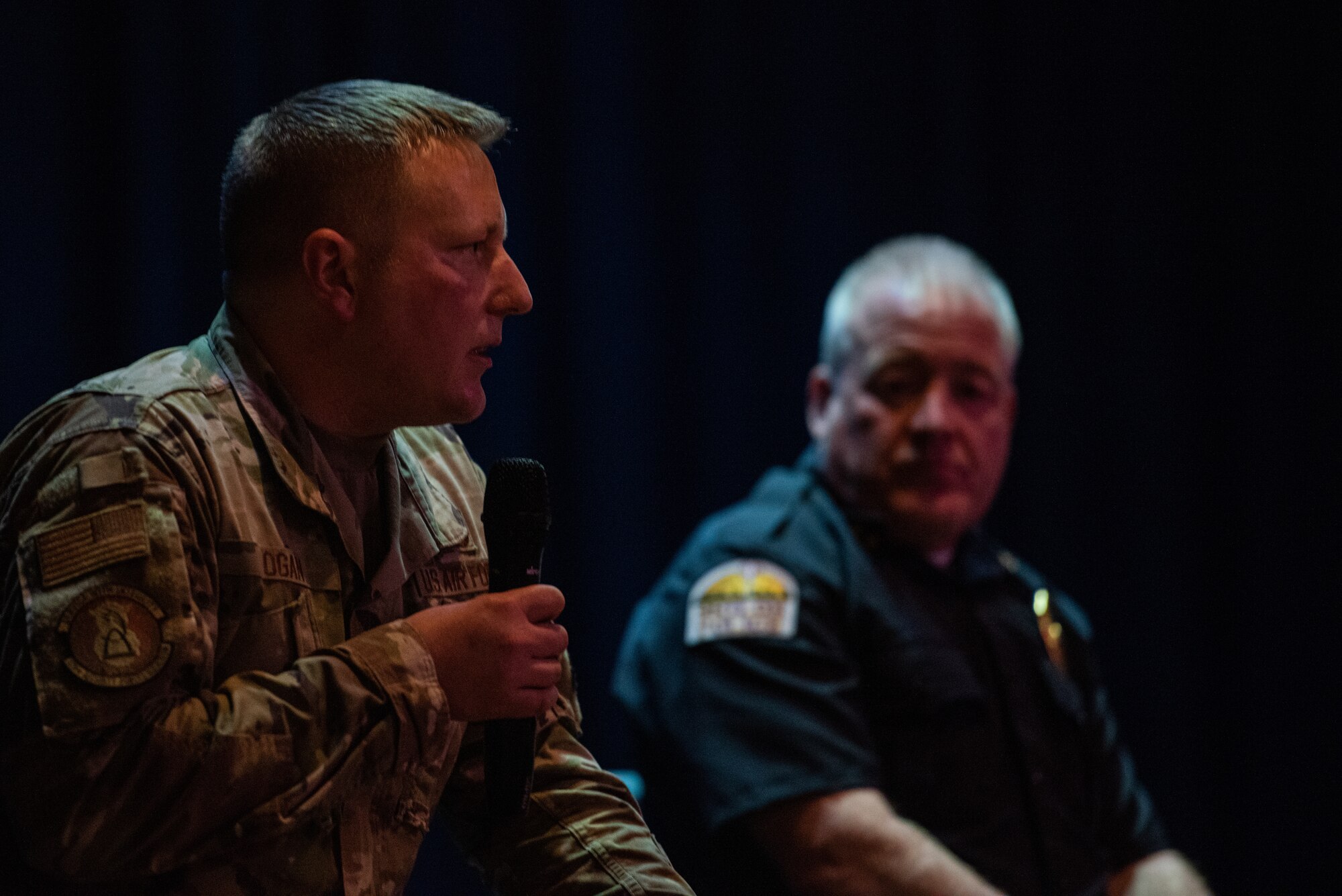 Military member speaking into microphone.