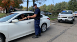 A Coast Guard maritime enforcement specialist conducts ID checks maintaining base security.