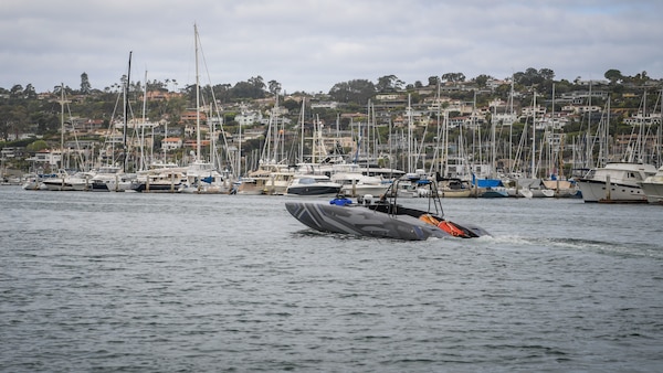 System technicians perform a safety test on a MANTAS T38 Devil Ray unmanned surface vehicle (USV) in San Diego Bay for an operational test run.