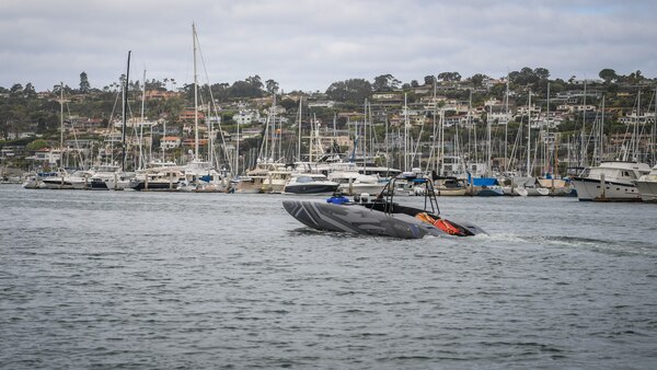 System technicians perform a safety test on a MANTAS T38 Devil Ray unmanned surface vehicle (USV) in San Diego Bay for an operational test run.