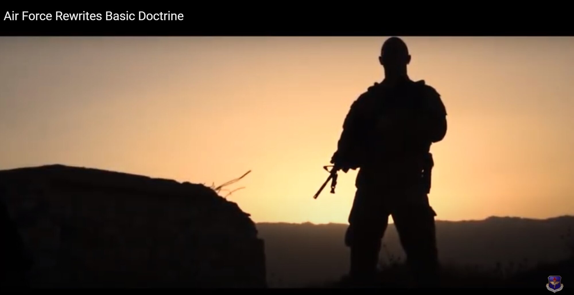 A military member is silhouetted against the sunset