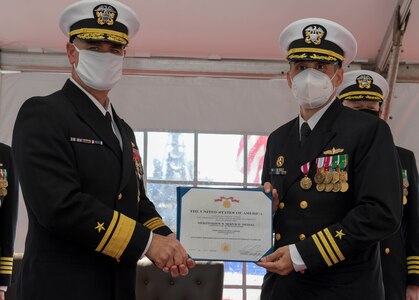 NAVAL STATION NORFOLK – Rear Adm. Brendan McLane, commander, Surface Force Atlantic, awards Cmdr. Matthew Erdner with the Meritorious Service medal during a change of command ceremony on board the Arleigh Burke-class destroyer USS Mason (DDG 87). During the ceremony, Cmdr. Stephen Valerio relieved Erdner of command following at 18-month tour as commanding officer. (U.S. Navy photo by Mass Communication Specialist 2nd Class Jacob Milham/Released)