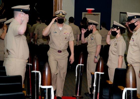 NEWPORT, R.I. (April 22, 2021) Capt. Christopher Alexander passes through sideboys during the Surface Warfare Schools Command  (SWSC) change of command ceremony at Naval Station (NAVSTA) Newport R.I., April 22, 2021. During the ceremony, Alexander was relieved by Capt. Alexis Walker as SWSC’s commanding officer. (U.S. Navy photo by Mass Communication Specialist 2nd Class Derien C. Luce)