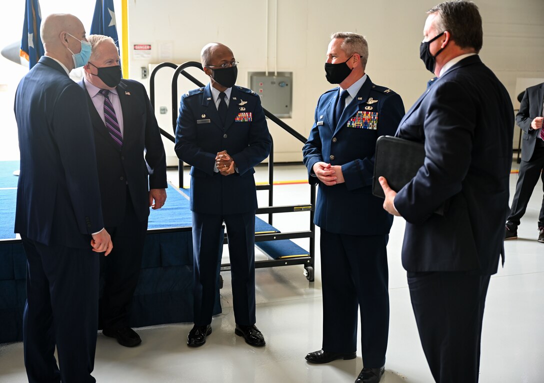 Picture of 5 men standing in semi-circle and talking