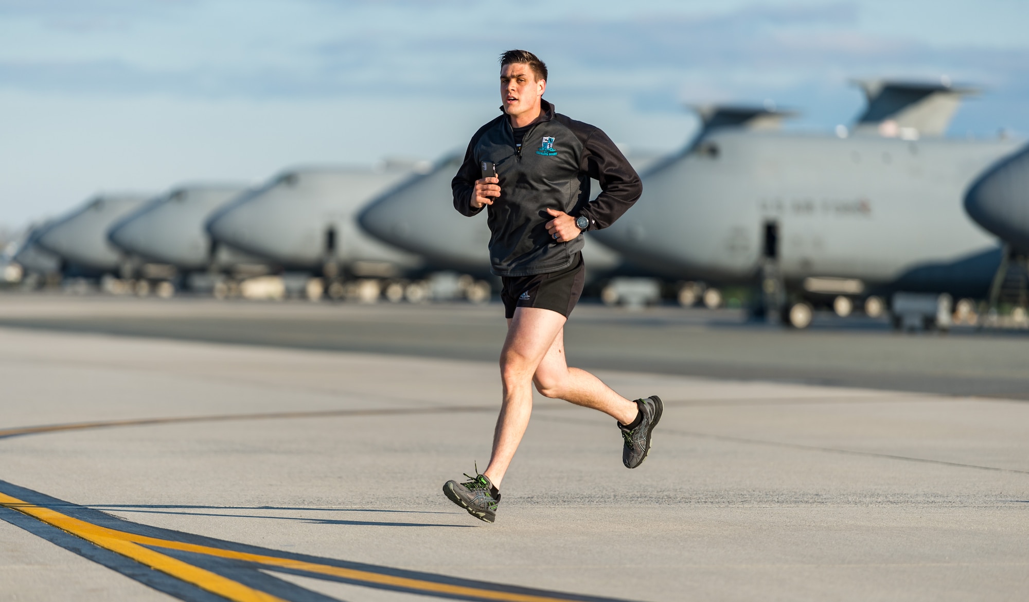 Staff Sgt. Timothy Clayton-Cornell, 736th Aircraft Maintenance Squadron flying crew chief, runs toward the finish line during the Wingman Day 2.25-mile run the runway event on Dover Air Force Base, Delaware, April 16, 2021. The run was one of more than 20 different events held to promote physical and mental resilience. (U.S. Air Force photo by Roland Balik)