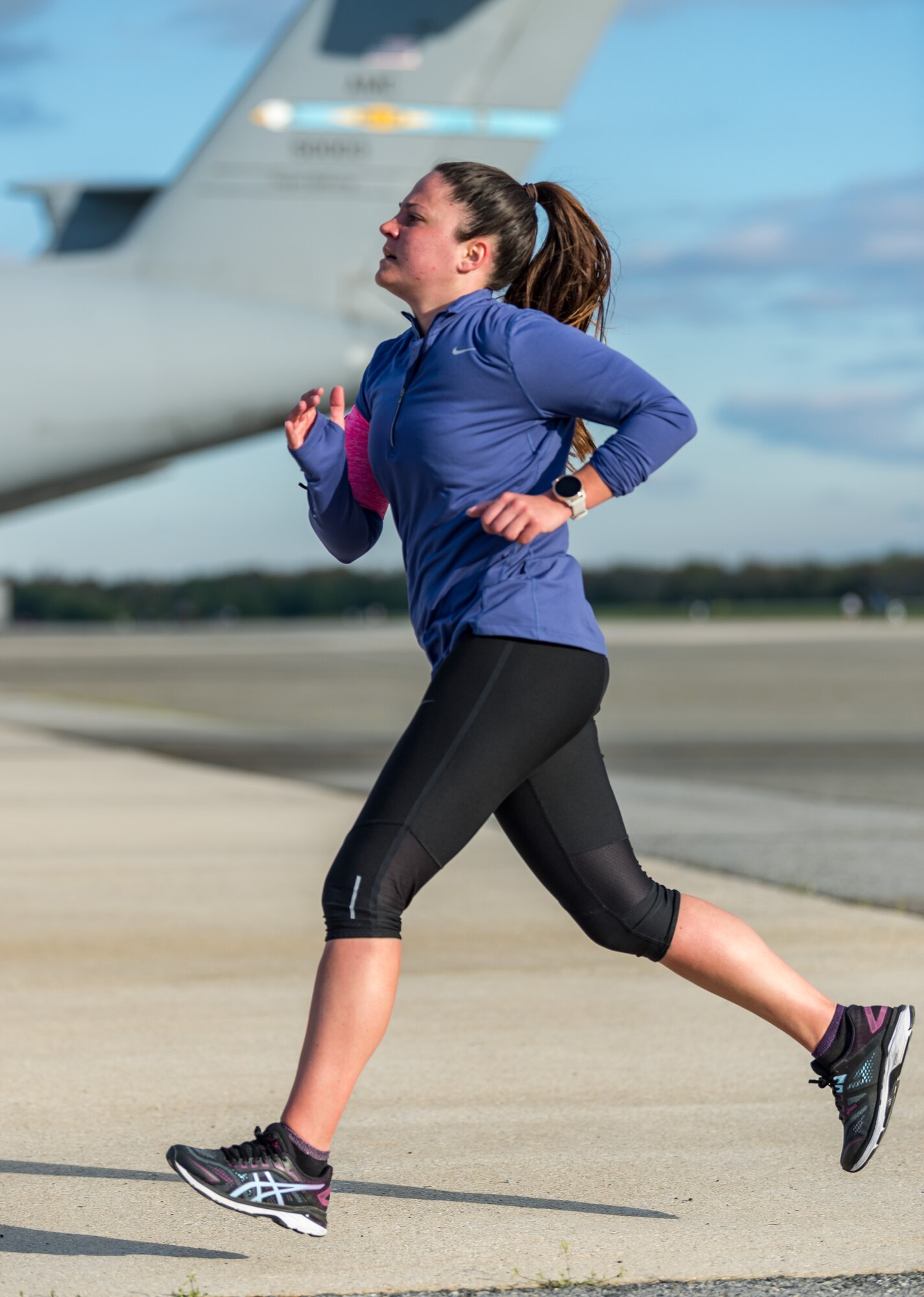 Master Sgt. Jessica Boyanton, 436th Medical Group public health flight chief, runs toward the finish line during the Wingman Day 2.25-mile run the runway event on Dover Air Force Base, Delaware, April 16, 2021. The run was one of more than 20 different events held to promote physical and mental resilience. (U.S. Air Force photo by Roland Balik)