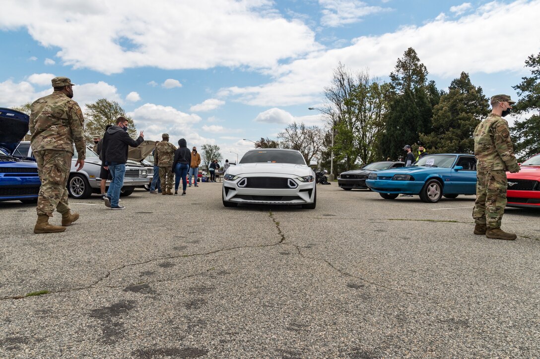 A car departs the Wingman Day car and bike show on Dover Air Force Base, Delaware, April 16, 2021. Thirty-six cars and four motorcycles entered the show. (U.S. Air Force photo by Roland Balik)