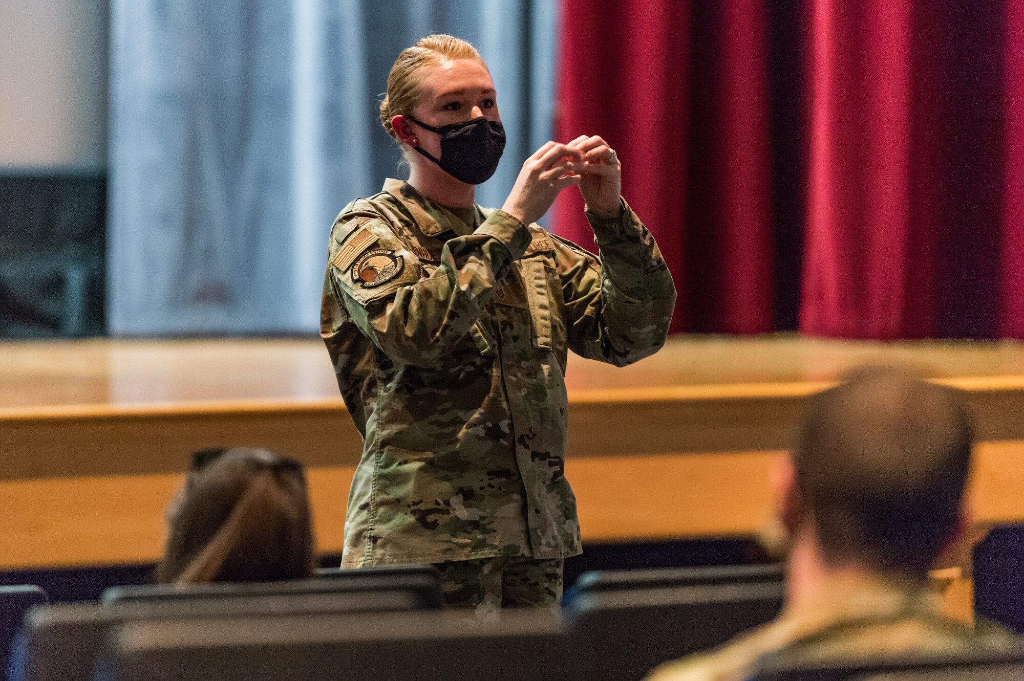 Master Sgt. Jessica Nienhueser, 436th Medical Support Squadron superintendent, speaks to attendees at the base theater on Dover Air Force Base, Delaware, April 16, 2021. Nienhueser discussed positive work environments and growing work relationships, promoting mental resilience during Wingman Day. (U.S. Air Force photo by Roland Balik)
