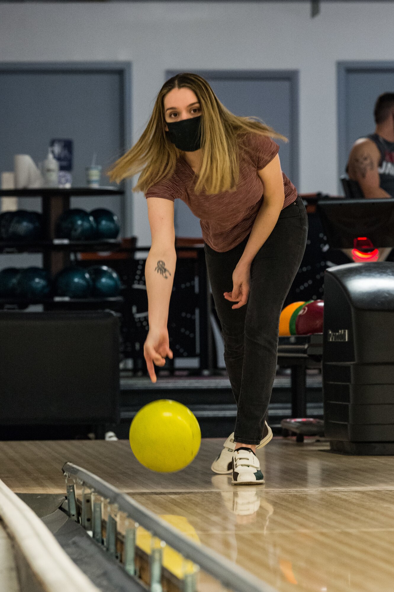 Staff Sgt. Jasmine Taylor, 436th Aerial Port Squadron air transportation upgrade training facilitator, focuses on the pins as she releases her bowling ball down the lane on Dover Air Force Base, Delaware, April 16, 2021. Taylor and other Team Dover members bowled during Wingman Day to promote physical and mental resilience. (U.S. Air Force photo by Roland Balik)