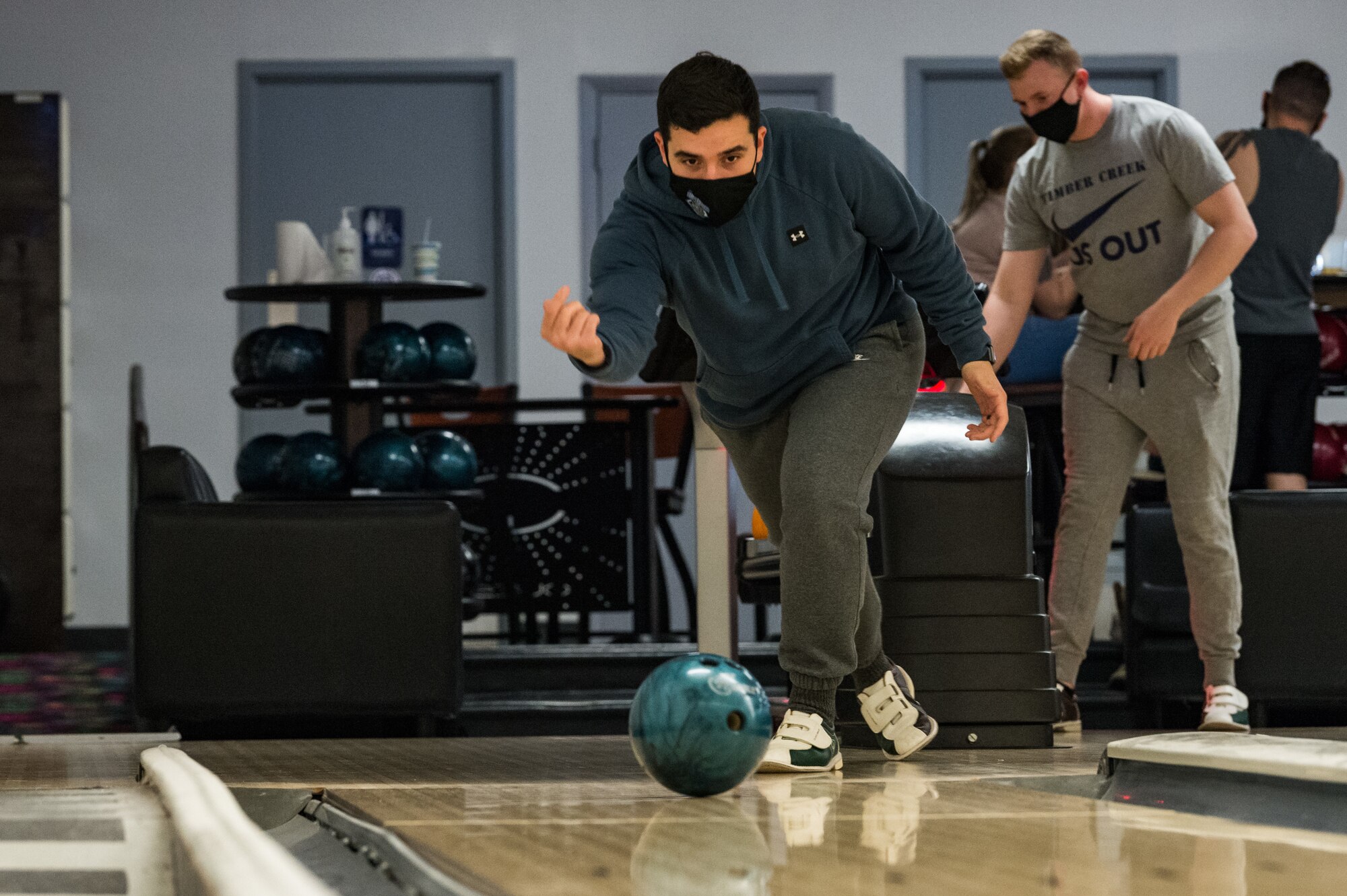 Senior Airman Cristian Ortiz, 436th Aerial Port Squadron unit security manager, releases a bowling ball down the lane on Dover Air Force Base, Delaware, April 16, 2021. Ortiz and other Team Dover members bowled during Wingman Day to promote physical and mental resilience. (U.S. Air Force photo by Roland Balik)