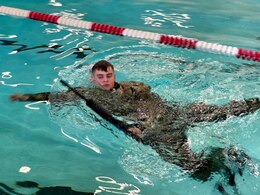 soldier in water doing water survival training
