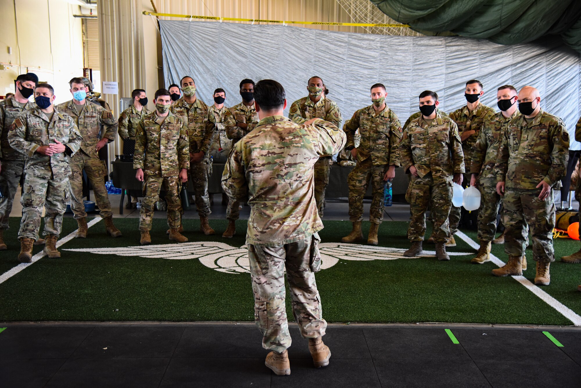 A photo of an airmen briefing a group of airmen