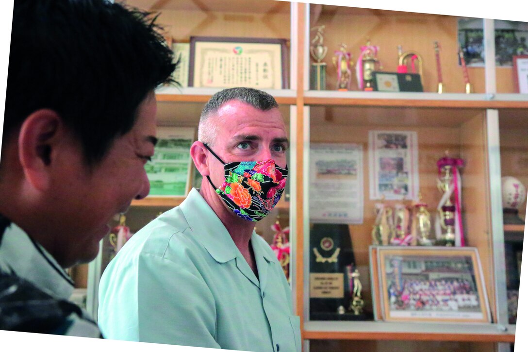 Col. Perry enjoys conversation with Futoshi Kohagura (left), Henoko district mayor, and Naomi Miyagi, Toyohira district mayor (not shown), in fluent Japanese.