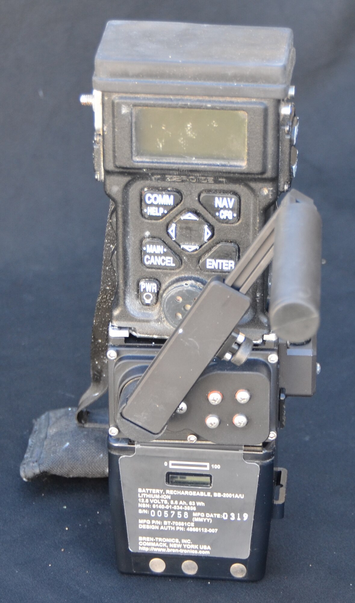 A removable hand-crank provides on-the-go power to the Surge charging device, shown here with the Combat Survivor Evader Locator radio (top) and battery (bottom) all connected. (Photo courtesy of Combat Power Solutions, LLC)