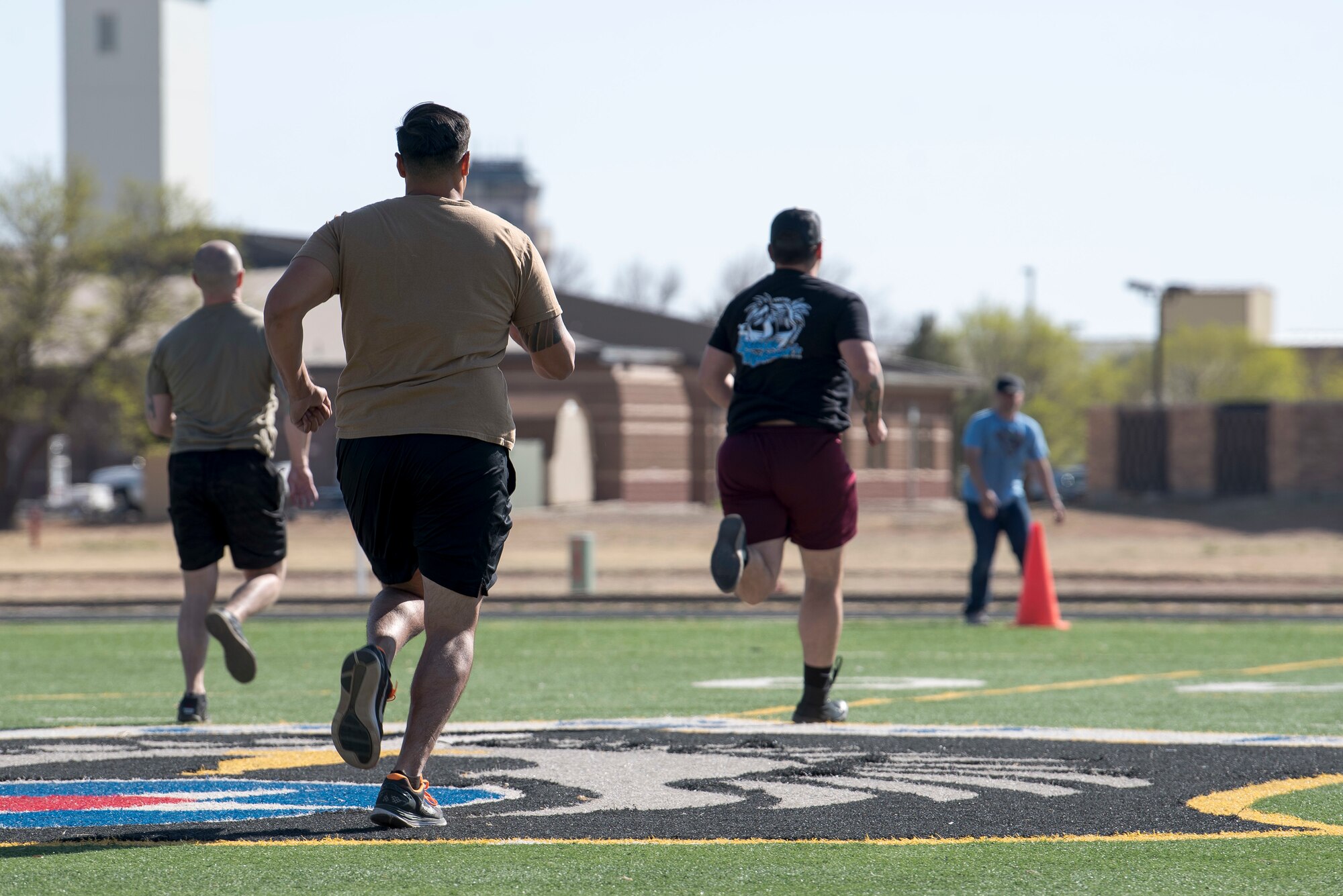 Participants of the 2nd Annual Reaper Smoke Competition & Symposium race to the finish of the fitness competition at Cannon Air Force Base, N.M., April 13, 2021. This year's exercise consisted of athletic contests, flight simulation contests, immersion flights, and guided tours. (U.S. Air Force photo by Senior Airman Vernon R. Walter III)