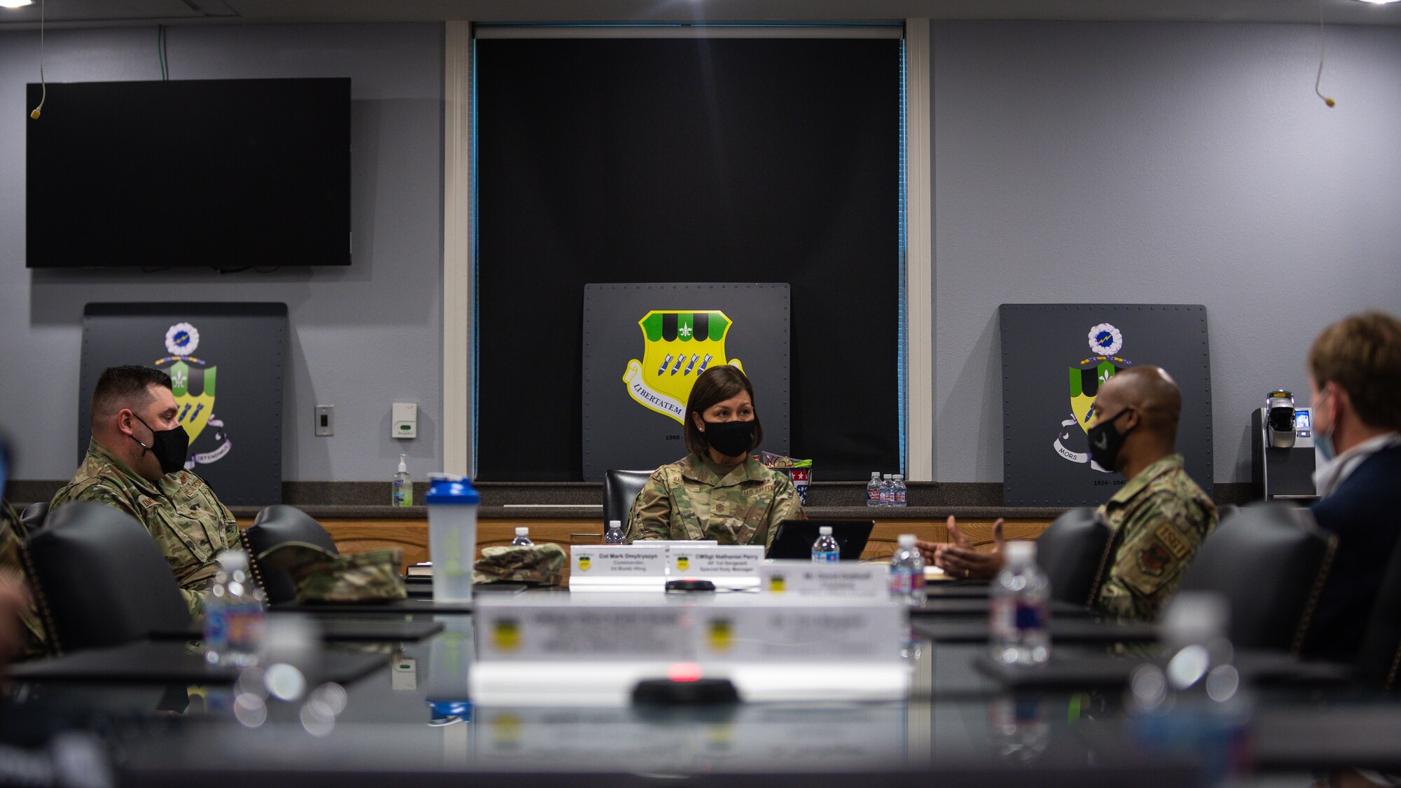 Chief Master Sergeant of the Air Force JoAnne S. Bass (center), talks with Col. Mark C. Dmytryszyn, 2nd Bomb Wing commander (left), and Chief Master Sgt. Mike Perry, Air Force First Sergeant special duty manager (right), at Barksdale Air Force Base, Louisiana, April 21, 2021.